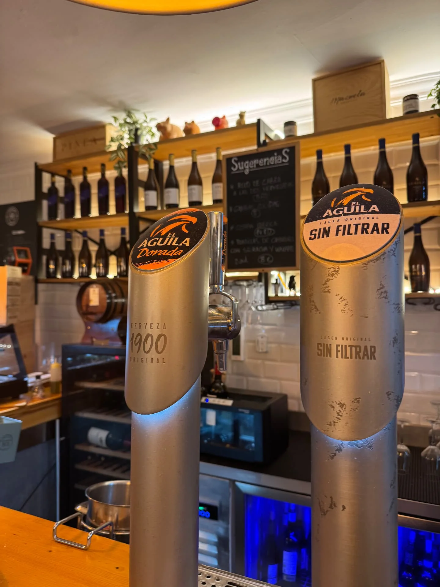 Tiradores de cerveza El Águila en la barra